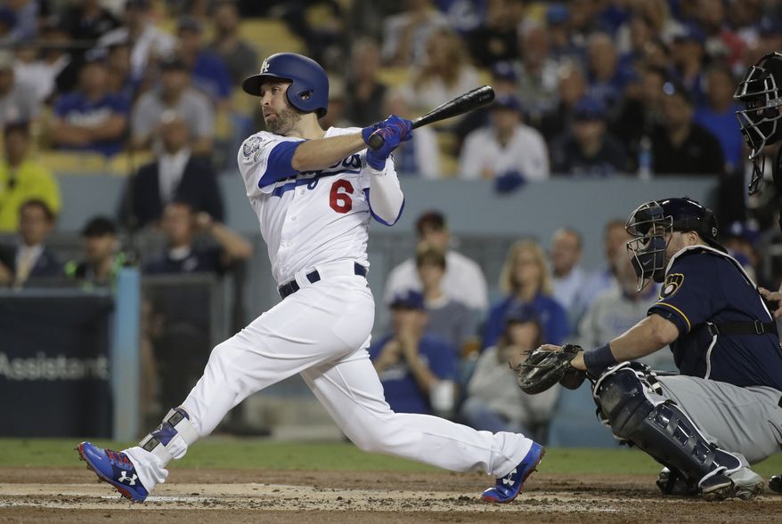FILE - In this Oct. 16, 2018, file photo, Los Angeles Dodgers' Brian Dozier hits an RBI single during the first inning of Game 4 of the National League Championship Series baseball game against the Milwaukee Brewers, in Los Angeles. A person familiar with the negotiations tells The Associated Press that free-agent second baseman Brian Dozier and the Washington Nationals have agreed to a $9 million, one-year contract, subject to the successful completion of a physical exam. The person confirmed the deal on condition of anonymity Thursday, Jan. 10, 2019, because neither the club nor player had announced anything. (AP Photo/Jae Hong, File)