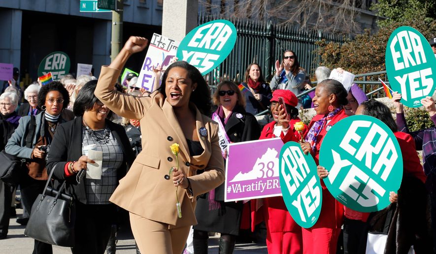 Delegate Jennifer Carroll Foy, D-Prince William, cheers on Equal Rights Amendment demonstrators outside the Capitol in Richmond, Va., Wednesday, Jan. 9, 2019. (AP Photo/Steve Helber)