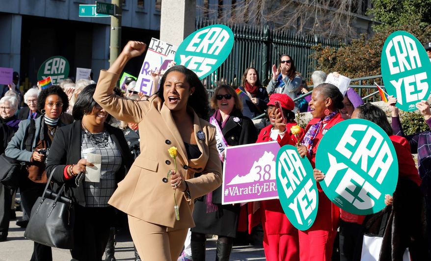 Delegate Jennifer Carroll Foy, D-Prince William, cheers on Equal Rights Amendment demonstrators outside the Capitol in Richmond, Va., Wednesday, Jan. 9, 2019. (AP Photo/Steve Helber)