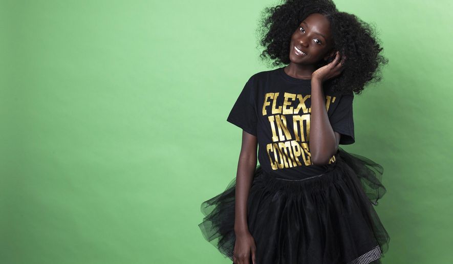 In this Dec. 19, 2018 photo, social media personality Kheris Rogers poses for a portrait in Los Angeles. Rogers launched her own fashion line with T-shirts sporting, "Flexin' in My Complexion," along with backpacks reading "The Miseducation of Melanin" and other apparel and accessories. (Photo by Rebecca Cabage/Invision/AP)