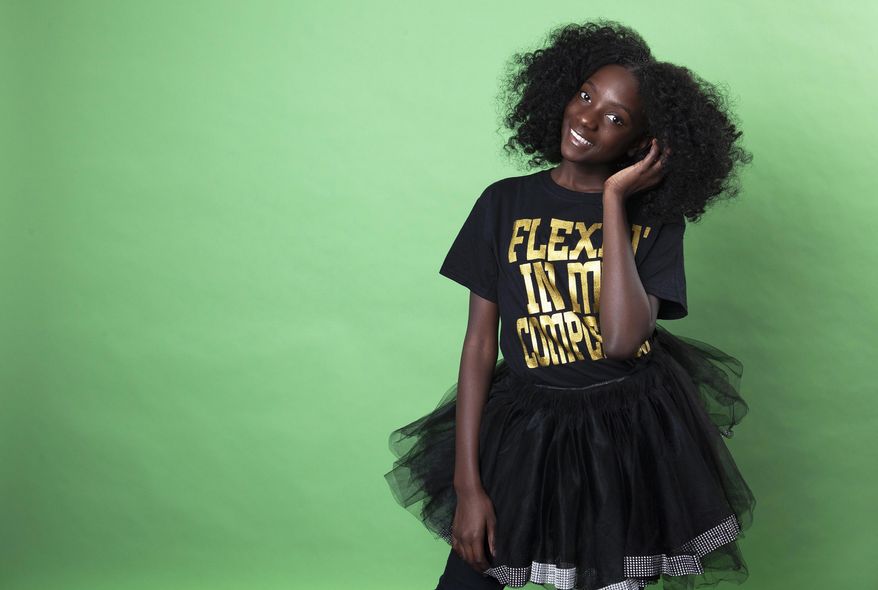 In this Dec. 19, 2018 photo, social media personality Kheris Rogers poses for a portrait in Los Angeles. Rogers launched her own fashion line with T-shirts sporting, "Flexin' in My Complexion," along with backpacks reading "The Miseducation of Melanin" and other apparel and accessories. (Photo by Rebecca Cabage/Invision/AP)