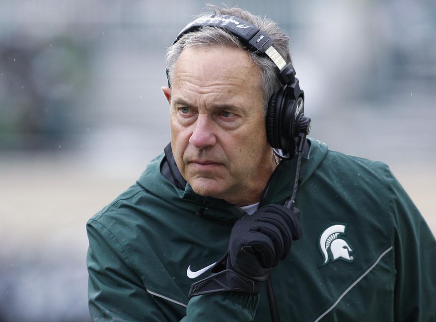 FILE - In this Oct. 27, 2018, file photo, Michigan State coach Mark Dantonio watches the second quarter of the team's NCAA college football game against Purdue in East Lansing, Mich. Brad Salem is taking over as Michigan State's offensive coordinator after Dantonio rearranged several roles on his staff. The Spartans did not announce any firings or new hires Thursday, Jan. 10, but several assistants will be in different jobs. Salem moves from quarterbacks coach to offensive coordinator, and he'll also coach running backs. Dave Warner and Jim Bollman, who have been co-offensive coordinators for Michigan State, will no longer have that duty. Warner will coach quarterbacks, and Bollman will coach the offensive line. (AP Photo/Al Goldis, File)
