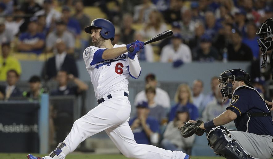 FILE - In this Oct. 16, 2018, file photo, Los Angeles Dodgers' Brian Dozier hits an RBI single during the first inning of Game 4 of the National League Championship Series baseball game against the Milwaukee Brewers, in Los Angeles. A person familiar with the negotiations tells The Associated Press that free-agent second baseman Brian Dozier and the Washington Nationals have agreed to a $9 million, one-year contract, subject to the successful completion of a physical exam. The person confirmed the deal on condition of anonymity Thursday, Jan. 10, 2019, because neither the club nor player had announced anything. (AP Photo/Jae Hong, File) **FILE**