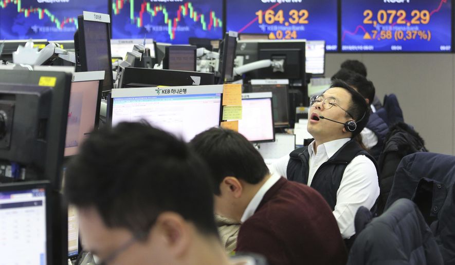 A currency trader shouts at the foreign exchange dealing room of the KEB Hana Bank headquarters in Seoul, South Korea, Thursday, Jan. 10, 2019. Asian markets were mostly lower Thursday as U.S. and Chinese officials wrapped up three days of talks in Beijing without significant breakthroughs. (AP Photo/Ahn Young-joon)