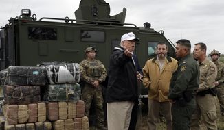 President Donald Trump tours the U.S. border with Mexico at the Rio Grande on the southern border, Thursday, Jan. 10, 2019, in McAllen, Texas. (AP Photo/ Evan Vucci)