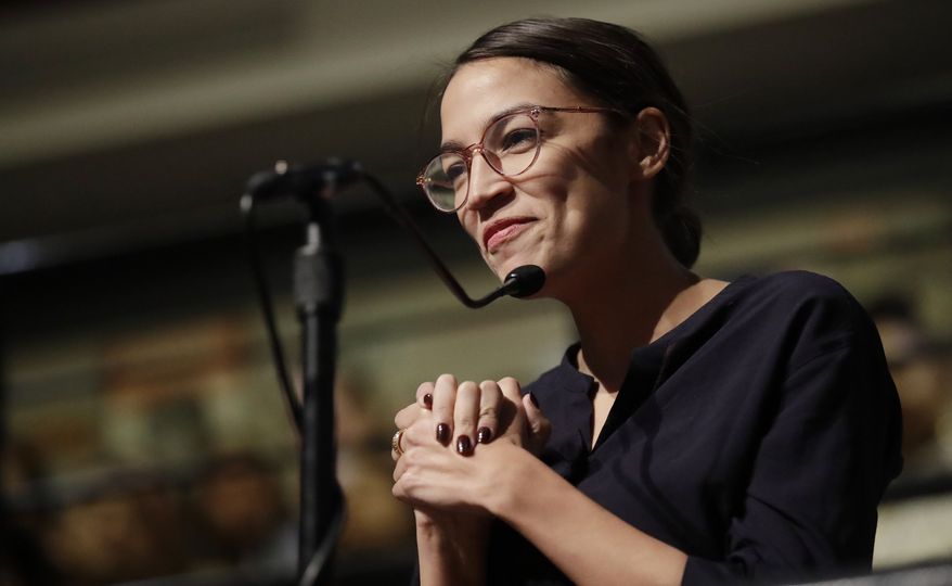 In this Dec. 6, 2018, file photo, Democrat Alexandria Ocasio-Cortez, who won her bid for a seat in the House of Representatives in New York&#39;s 14th Congressional District, asks 2014 Nobel Laureate Malala Yousafzai a question at the Kennedy School&#39;s Institute of Politics at Harvard University in Cambridge, Mass. (AP Photo/Charles Krupa) ** FILE **