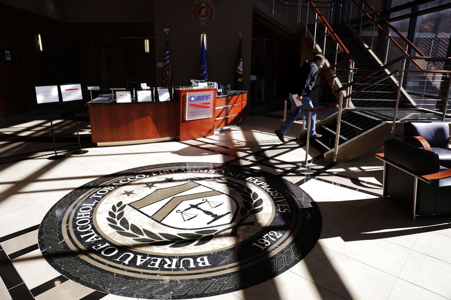 A worker walks through the empty lobby of the federal Bureau of Alcohol, Tobacco, Firearms and Explosives' National Center for Explosives Training and Research in Huntsville, Ala., Wednesday, Jan. 9, 2019. About 70 federal agencies are located at the Army's sprawling Redstone Arsenal, and more than half the area economy is tied to Washington spending. (AP Photo/David Goldman)