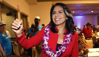 In this Nov. 6, 2018, file photo, Rep. Tulsi Gabbard, D-Hawaii, greets supporters in Honolulu. Gabbard has announced she’s running for president in 2020. The 37-year-old Gabbard said in a CNN interview slated to air Saturday night that she will be formally announcing her candidacy within the week. (AP Photo/Marco Garcia, File)