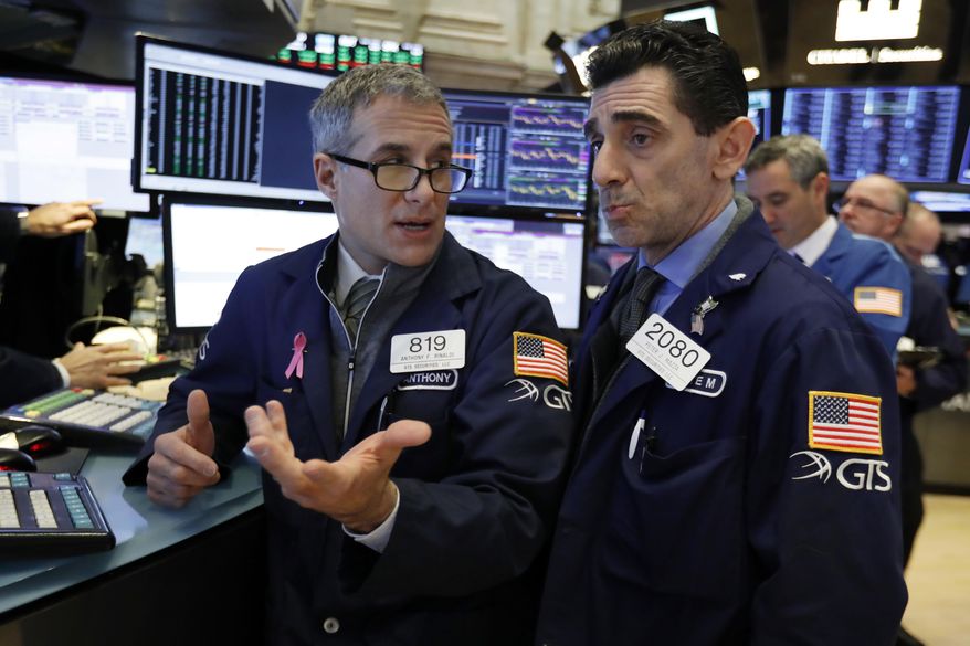 FILE- In this Jan. 4, 2019, file photo specialists Anthony Rinaldi, left, and Peter Mazza confer as they work on the floor of the New York Stock Exchange. The U.S. stock market opens at 9:30 a.m. EST on Friday, Jan. 11. (AP Photo/Richard Drew, FIle)