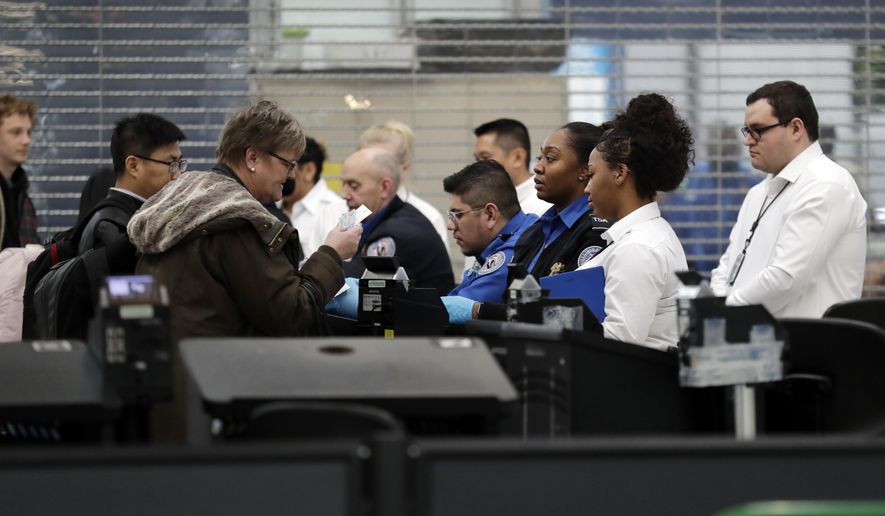 Transportation Security Administration officers work at a checkpoint at O&#x27;Hare airport in Chicago, Friday, Jan. 11, 2019, as the partial government shutdown continues. (AP Photo/Nam Y. Huh)