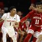 Maryland guard Anthony Cowan Jr., left, drives against Indiana guard Devonte Green (11) and forward Juwan Morgan in the first half of an NCAA college basketball game, Friday, Jan. 11, 2019, in College Park, Md. (AP Photo/Patrick Semansky)