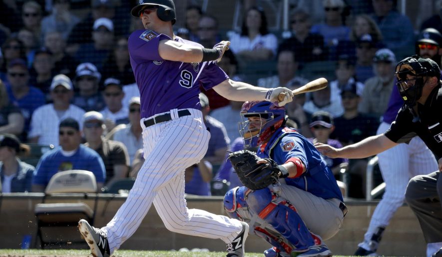 FILE - In this March 5, 2018, file photo, Colorado Rockies' DJ LeMahieu bats during a spring baseball game against the Chicago Cubs, in Scottsdale, Ariz. A person familiar with the negotiations tells The Associated Press that Gold Glove-winning free agent second baseman D.J. LeMahieu and the Yankees are nearing agreement on a two-year contract, a deal that would appear to eliminate New York as a destination for Manny Machado. The person spoke on condition of anonymity Friday, Jan. 11, 2019, because no agreement had been announced. (AP Photo/Chris Carlson, File)