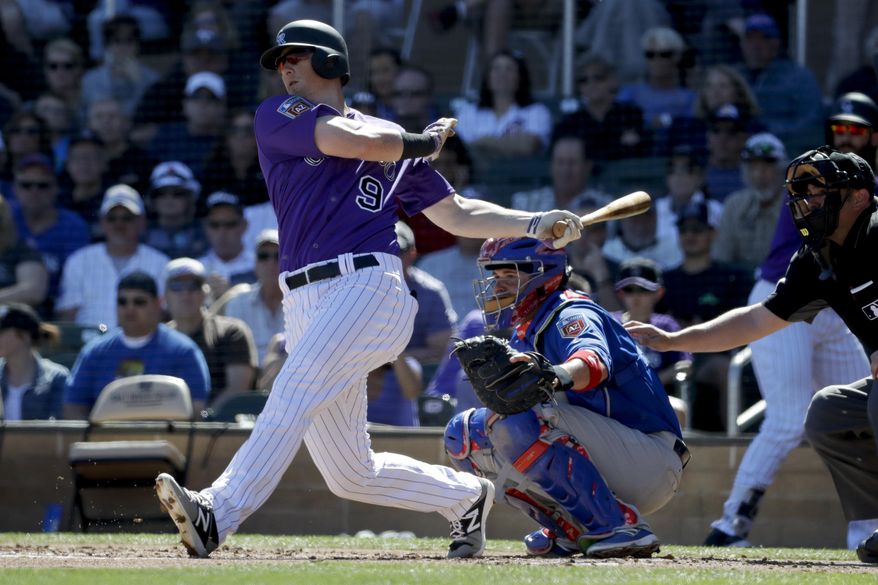 FILE - In this March 5, 2018, file photo, Colorado Rockies' DJ LeMahieu bats during a spring baseball game against the Chicago Cubs, in Scottsdale, Ariz. A person familiar with the negotiations tells The Associated Press that Gold Glove-winning free agent second baseman D.J. LeMahieu and the Yankees are nearing agreement on a two-year contract, a deal that would appear to eliminate New York as a destination for Manny Machado. The person spoke on condition of anonymity Friday, Jan. 11, 2019, because no agreement had been announced. (AP Photo/Chris Carlson, File)