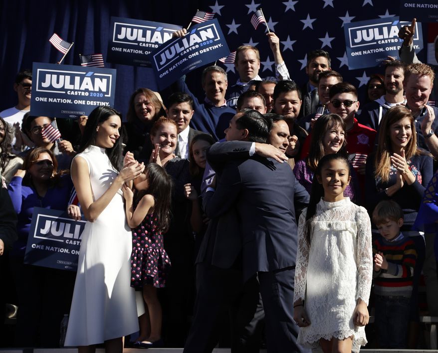 Former San Antonio Mayor and Housing and Urban Development Secretary Julian Castro, center right, is embraced by his twin brother U.S. Rep. Joaquin Castro (D-San Antonio), center left, during an event where Julian Castro announced his decision to seek the 2020 Democratic presidential nomination, Saturday, Jan. 12, 2019, in San Antonio. (AP Photo/Eric Gay)