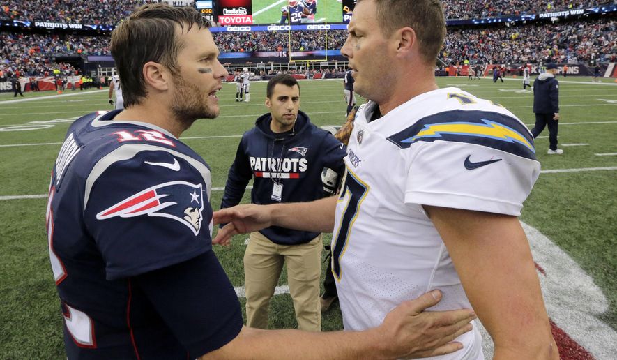 FILE - In this Oct. 29, 2017, file photo, New England Patriots quarterback Tom Brady (12) and Los Angeles Chargers quarterback Philip Rivers (17) speak at midfield after an NFL football game, in Foxborough, Mass. The Chargers and Patriots meet in a divisional playoff game on Sunday, Jan. 13, 2019. (AP Photo/Steven Senne, File)