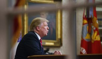 In this Tuesday, Jan. 8, 2019, file photo seen from a window outside the Oval Office, President Donald Trump gives a prime-time address about border security at the White House in Washington. (AP Photo/Carolyn Kaster, File)