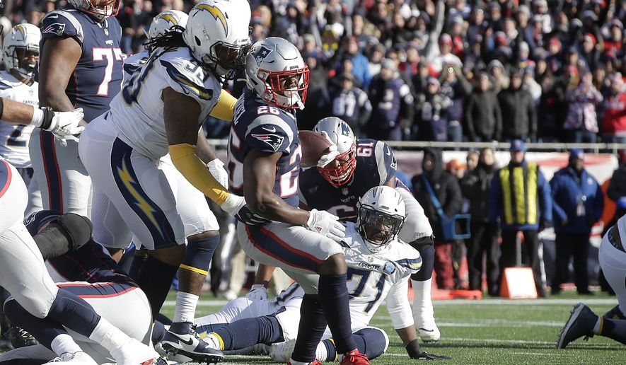 New England Patriots running back Sony Michel (26) scores a touchdown in front of Los Angeles Chargers defensive tackle Darius Philon (93) during the first half of an NFL divisional playoff football game, Sunday, Jan. 13, 2019, in Foxborough, Mass. (AP Photo/Steven Senne)