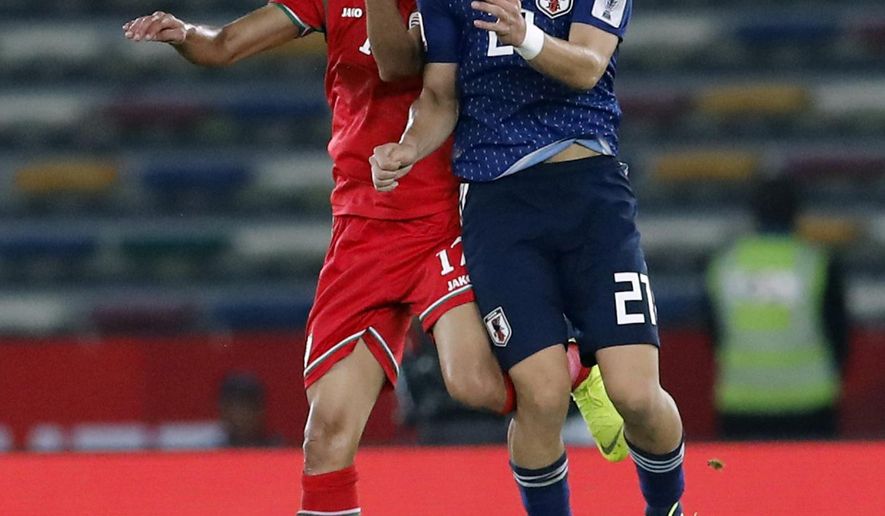 Japan's midfielder Ritsu Doan, right, goes for a header with Oman's midfielder Ahmed Al Mahaijri during the AFC Asian Cup group F soccer match between Japan and Oman at Zayed Sports City Stadium in Abu Dhabi, United Arab Emirates, Sunday, Jan. 13, 2019. (AP Photo/Hassan Ammar)