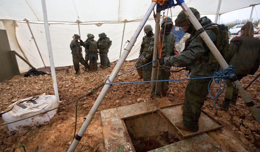 File - In this Wednesday, Dec. 19, 2018 file photo, Israeli soldiers stand around the opening of a hole that leads to a tunnel that the army says crosses from Lebanon to Israel, near Metula. The Israel military says it has concluded "Operation Northern Shield" by uncovering the sixth and final Hezbollah attack tunnel from Lebanon. (AP Photo/Sebastian Scheiner, File)