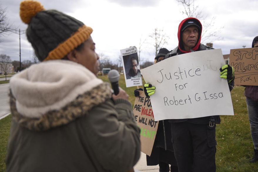 This photo taken April 17, 2018, shows observers in the Court organizer Marcina Cole rallying a group gathered outside Oak Park City Hall on Tuesday calling to "Stop Police Terrorism and Stop Gun Violence" in the wake of recent fatal police-involved shootings of mentally ill men. Robert G. Issa, 23 of Troy, was fatally shot outside his home April 9 when officers responded to a call about his violent and erratic behavior. Todd Stone, 48, also suffered from bipolar disorder and was fatally shot by Oak Park police in his home in December of 2017. (Tanya Moutzalias/Ann Arbor News via AP)