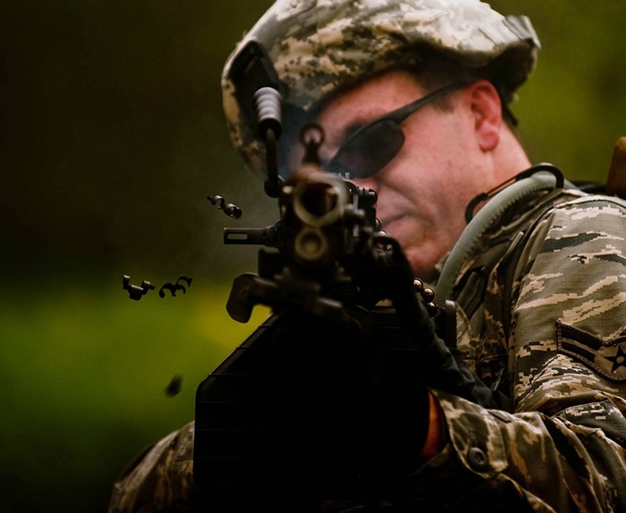 M249 light machine gun - Airman 1st Class Seth Lamb, a member of the 122nd Security Forces Squadron, fires a burst of blanks from his M249 light machine gun at enemy combatants during an ambush exercise July 29, 2015, at the Combat Readiness Training Center in Alpena, Mich. Airmen from the 122nd Fighter Wing participated in the exercise as part of their annual training. (U.S. Air National Guard photo/Staff Sgt. William Hopper)