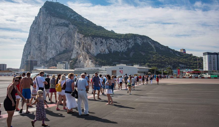 In this Sept. 10, 2018, file photo, people cross the Gibraltar airport to participate in National Day celebrations in the British territory of Gibraltar. Spanish Prime Minister Pedro Sanchez said in a press conference on Wednesday, Nov. 21, 2018, that his government is &quot;annoyed&quot; that the divorce agreement being prepared for Britain&#x27;s exit from the European Union doesn&#x27;t specify that Gibraltar&#x27;s future must be decided directly by officials in Madrid and London. (AP Photo/Marcos Moreno, File)