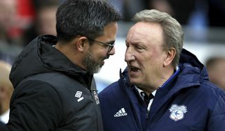 Huddersfield Town manager David Wagner, left, greets Cardiff City manager Neil Warnock during the English Premier League soccer match between Cardiff City and Huddersfield Town at the Cardiff City Stadium, Cardiff, Wales. Saturday, Jan. 12, 2019. (Nick Potts/PA via AP)