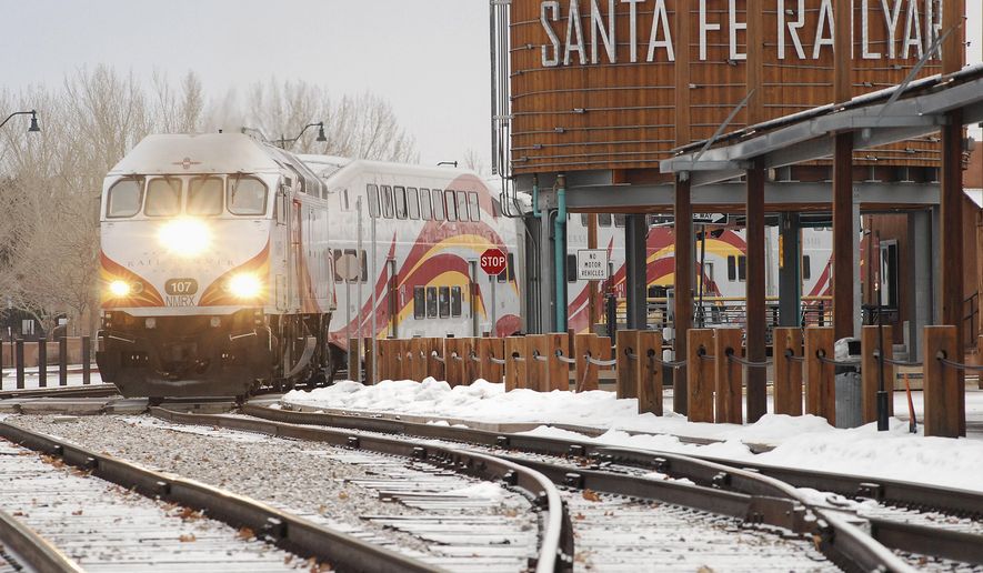 A New Mexico Rail Runner commuter train departs from Santa Fe, N.M, Monday, Jan. 14, 2019. A report released Monday by the Legislative Finance Committee shows there were more than three-quarters of a million trips taken during the last fiscal year. That is 37 percent below the peak of 1.2 million during the 2010 fiscal year. (AP Photo/Morgan Lee)