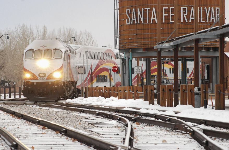 A New Mexico Rail Runner commuter train departs from Santa Fe, N.M, Monday, Jan. 14, 2019. A report released Monday by the Legislative Finance Committee shows there were more than three-quarters of a million trips taken during the last fiscal year. That is 37 percent below the peak of 1.2 million during the 2010 fiscal year. (AP Photo/Morgan Lee)