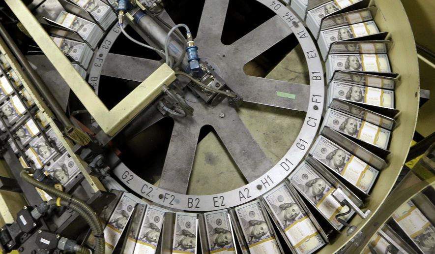 FILE - In this Sept. 24, 2013 file photo, freshly cut stacks of $100 bills make their way down the line at the Bureau of Engraving and Printing Western Currency Facility in Fort Worth, Texas. For years, cash languished at the bottom of the investment rankings, weighed down by nearly non-existent interest rates. But with the Federal Reserve raising short-term rates four times last year, money-market funds and online savings accounts began paying interest that came close to approaching inflation. (AP Photo/LM Otero, File)