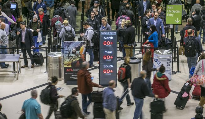Security lines at Hartsfield-Jackson International Airport in Atlanta stretch more than an hour-long amid the partial federal shutdown, causing some travelers to miss flights, Monday morning, Jan. 14, 2019. (John Spink/Atlanta Journal-Constitution via AP) ** FILE **