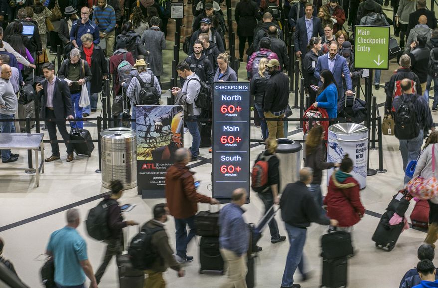 Security lines at Hartsfield-Jackson International Airport in Atlanta stretch more than an hour-long amid the partial federal shutdown, causing some travelers to miss flights, Monday morning, Jan. 14, 2019. (John Spink/Atlanta Journal-Constitution via AP) ** FILE **