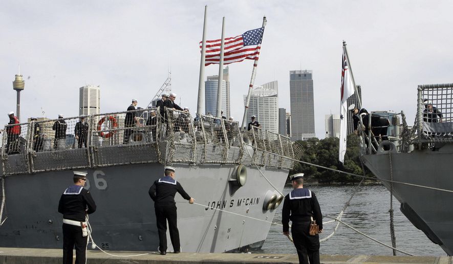 In this Aug. 20, 2008, file photo, Australian sailors tie up the USS John S McCain (DDG-56) as she arrives in Sydney, Australia, for the 100th Anniversary of the Great White Fleet. (AP Photo/Rob Griffith, File)