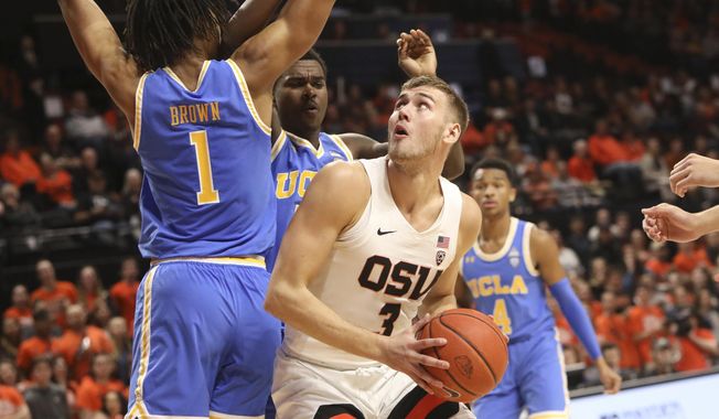 Oregon State&#x27;s Tres Tinkle looks for a path to the basket past UCLA&#x27;s Moses Brown during the first half of an NCAA college basketball game in Corvallis, Ore., Sunday, Jan. 13, 2019. (AP Photo/Amanda Loman)