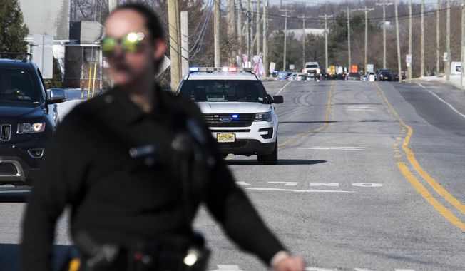 Officials respond to reports of an active shooter at a UPS facility Monday, Jan. 14, 2019 in Logan Township, N.J. (Joe Lamberti/Camden Courier-Post via AP)