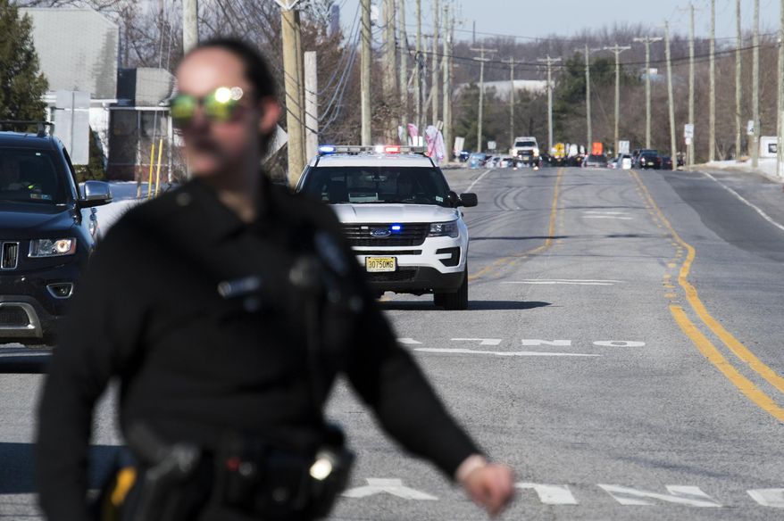 Officials respond to reports of an active shooter at a UPS facility Monday, Jan. 14, 2019 in Logan Township, N.J. (Joe Lamberti/Camden Courier-Post via AP)