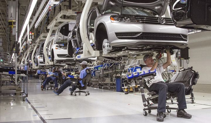 In this July 12, 2013, photo, employees at the Volkswagen plant in Chattanooga, Tenn., work on the assembly of Passat sedans. (AP Photo/Erik Schelzig) **FILE**