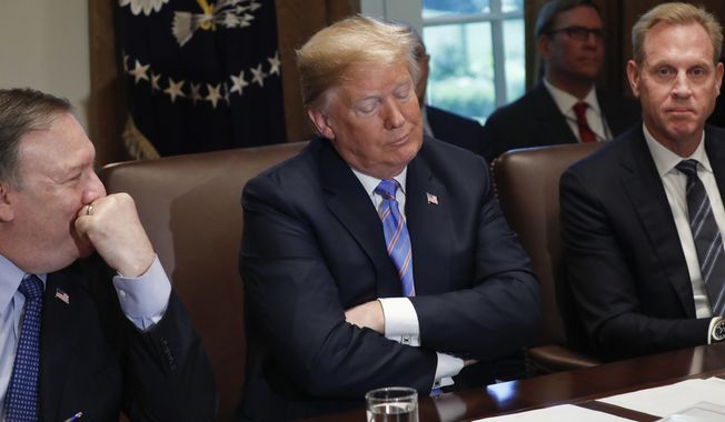 President Donald Trump, center, reacts to a question from a member of the media during his meeting with members of his cabinet in the Cabinet Room of the White House in Washington, Wednesday, July 18, 2018. Sitting with Trump are Secretary of State Mike Pompeo, left, and Deputy Secretary of Defense Patrick Shanahan, right. (AP Photo/Pablo Martinez Monsivais) **FILE**