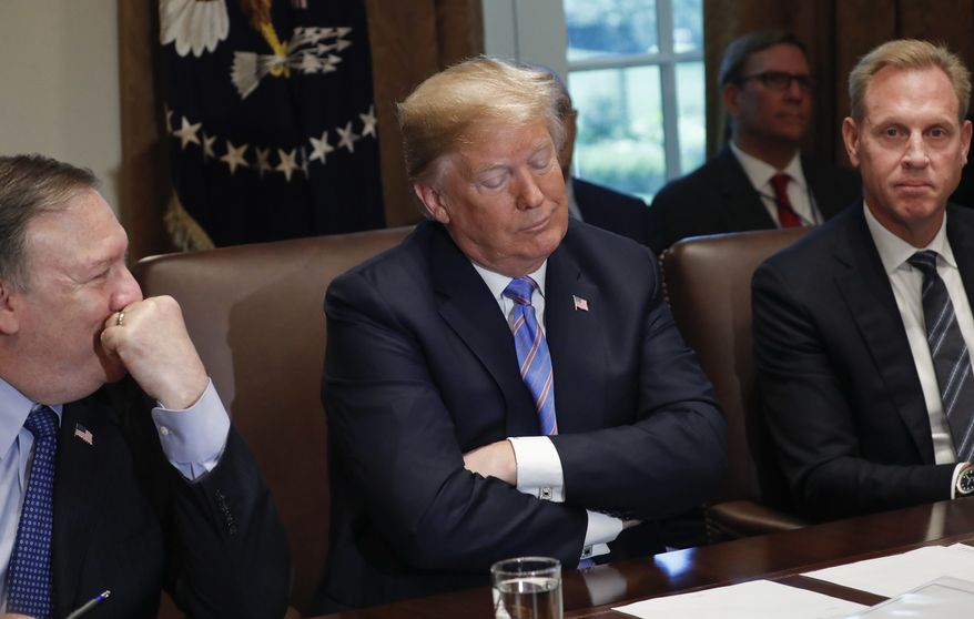 President Donald Trump, center, reacts to a question from a member of the media during his meeting with members of his cabinet in the Cabinet Room of the White House in Washington, Wednesday, July 18, 2018. Sitting with Trump are Secretary of State Mike Pompeo, left, and Deputy Secretary of Defense Patrick Shanahan, right. (AP Photo/Pablo Martinez Monsivais) **FILE**