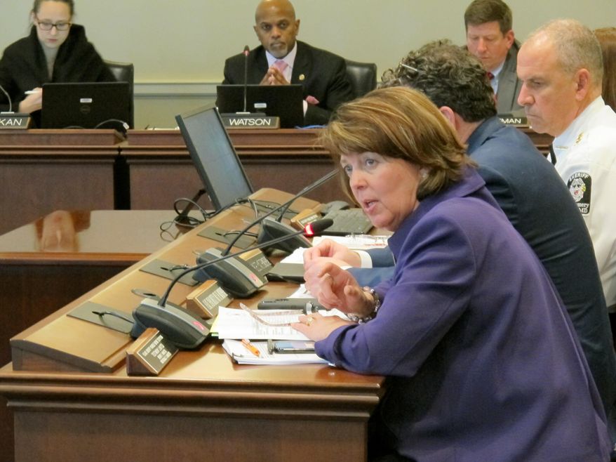 Del. Geraldine Valentino-Smith, a Prince George’s County Democrat, briefs Maryland lawmakers on Tuesday, Jan. 15, 2019, in Annapolis, Maryland, about initial implementation of a law that allows courts to temporarily restrict firearms access for people found to be a risk to themselves or others. Montgomery County Sheriff Darren Popkin, seated second to the right of Valentino-Smith, said of more than 300 protective orders in the first three months since the law took effect, five of them were school-related threats and four of those were “significant threats.” (AP Photo/Brian Witte)