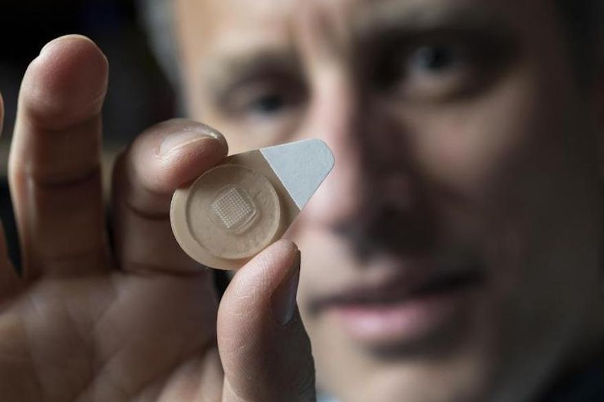 Regents Professor Mark Prausnitz holds an experimental microneedle contraceptive skin patch. Designed to be self-administered by women for long-acting contraception, the patch could provide a new family planning option. (Christopher Moore/Georgia Tech)
