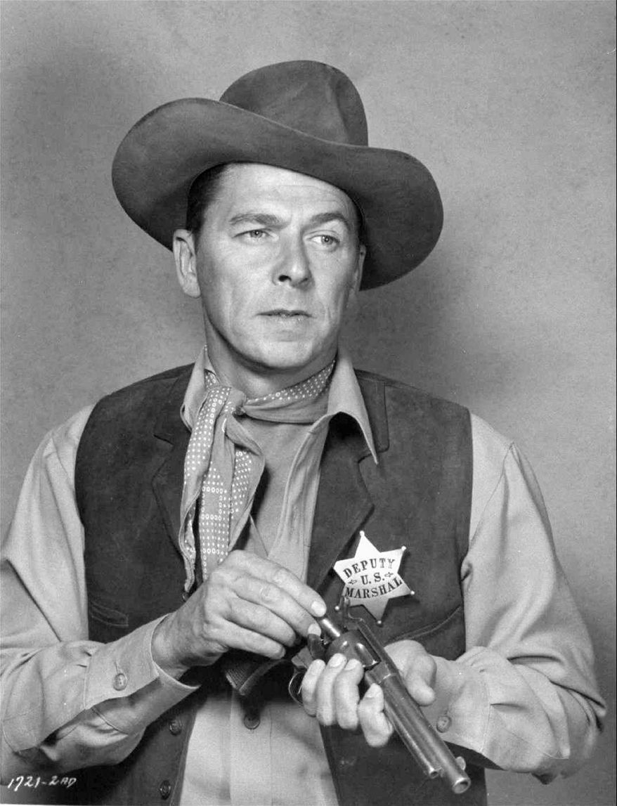 **  FILE**  Actor Ronald Reagan loads his gun in the 1953 western film &quot;Law and Order&quot;, in which Reagan plays a retired U.S. marshall who can&#39;t hang up his holster.  It is reported that Reagan died on Saturday, June 5, 2004 at 93.     (AP Photo)