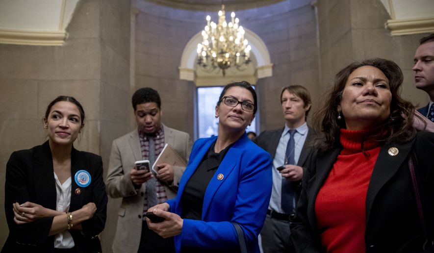 Rep. Alexandria Ocasio-Cortez, D-N.Y., left, Rep. Rashida Tlaib, D-Mich., second from left, and Rep. Veronica Escobar, D-Texas, second from right, wait for other freshman Congressmen to deliver a letter calling to an end to the government shutdown to deliver to the office of Senate Majority Leader Mitch McConnell of Ky., on Capitol Hill in Washington, Wednesday, Jan. 16, 2019. (AP Photo/Andrew Harnik)
