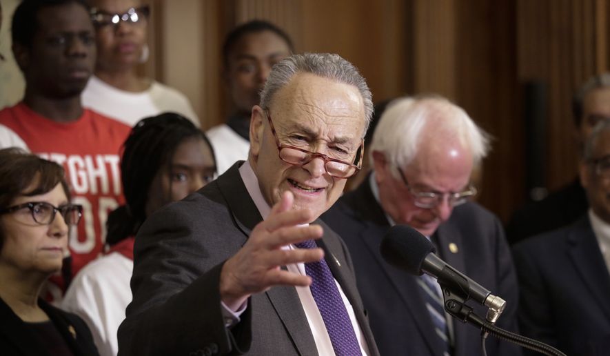 Surrounded by low-wage fast food workers, Senate Minority Leader Chuck Schumer, D-N.Y., joined at right by Senate Budget Committee Ranking Member Bernie Sanders, I-Vt., speaks out in favor of raising the minimum wage to $15 by 2024, on Capitol Hill in Washington, Wednesday, Jan. 16, 2019. (AP Photo/J. Scott Applewhite)
