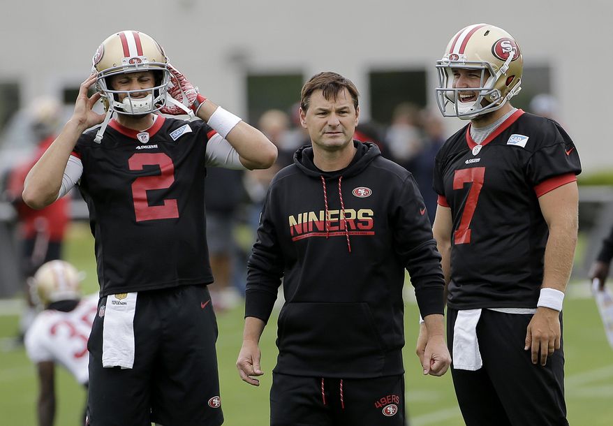 FILE - In this June 8, 2017, file photo, San Francisco 49ers quarterbacks coach Rich Scangarello, center, watches practice between Brian Hoyer, left, and Matt Barkley during the team's organized team activity at its NFL football training facility in Santa Clara, Calif. Scangarello was hired Wednesday, Jan. 16, 2019, by the Denver Broncos as offensive coordinator. (AP Photo/Jeff Chiu, File)
