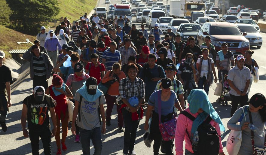 Migrants traveling in a group begin their journey toward the U.S. border as they walk along a highway in San Salvador, El Salvador, early Wednesday, Jan. 16, 2019. Migrants fleeing Central America&#x27;s Northern Triangle region comprising Honduras, El Salvador and Guatemala routinely cite poverty and rampant gang violence as their motivation for leaving. (AP Photo/Salvador Melendez)