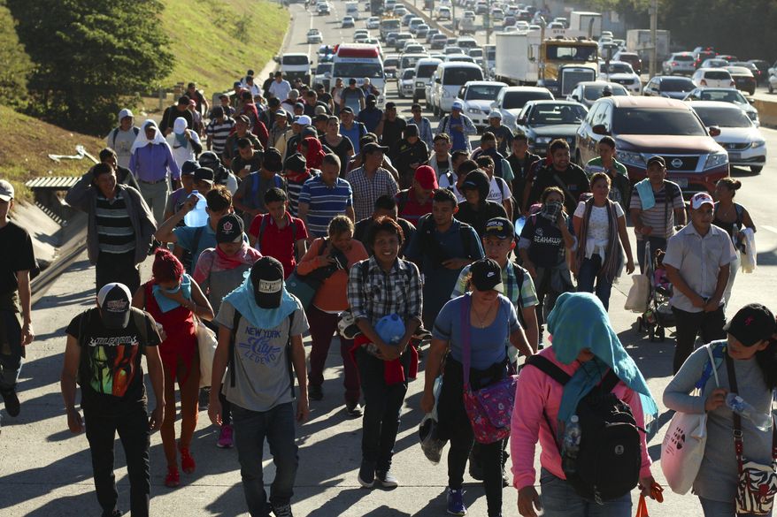 Migrants traveling in a group begin their journey toward the U.S. border as they walk along a highway in San Salvador, El Salvador, early Wednesday, Jan. 16, 2019. Migrants fleeing Central America&#x27;s Northern Triangle region comprising Honduras, El Salvador and Guatemala routinely cite poverty and rampant gang violence as their motivation for leaving. (AP Photo/Salvador Melendez)