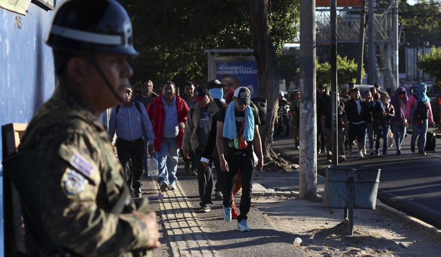 Police stand by as locals begin their journey north toward the U.S. border, during a migrant caravan passing through the capital of San Salvador, El Salvador, early Wednesday, Jan. 16, 2019. Migrants fleeing Central America&#39;s Northern Triangle region comprising Honduras, El Salvador and Guatemala routinely cite poverty and rampant gang violence as their motivation for leaving. (AP Photo/Salvador Melendez) **FILE**