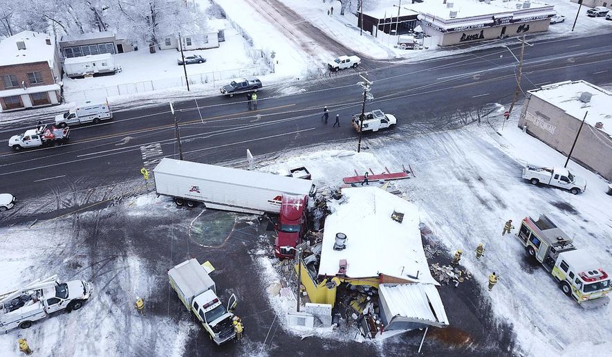 This drone photo released by the Utah Highway Patrol shows a restaurant that was hit by truck in Wellington, Utah, Wednesday, Jan. 16, 2019. Utah authorities say athe tractor-trailer rig crashed into the restaurant, flattening the business and injuring three people. (Utah Highway Patrol via AP)