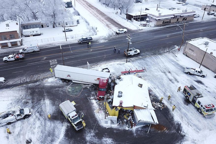 This drone photo released by the Utah Highway Patrol shows a restaurant that was hit by truck in Wellington, Utah, Wednesday, Jan. 16, 2019. Utah authorities say athe tractor-trailer rig crashed into the restaurant, flattening the business and injuring three people. (Utah Highway Patrol via AP)
